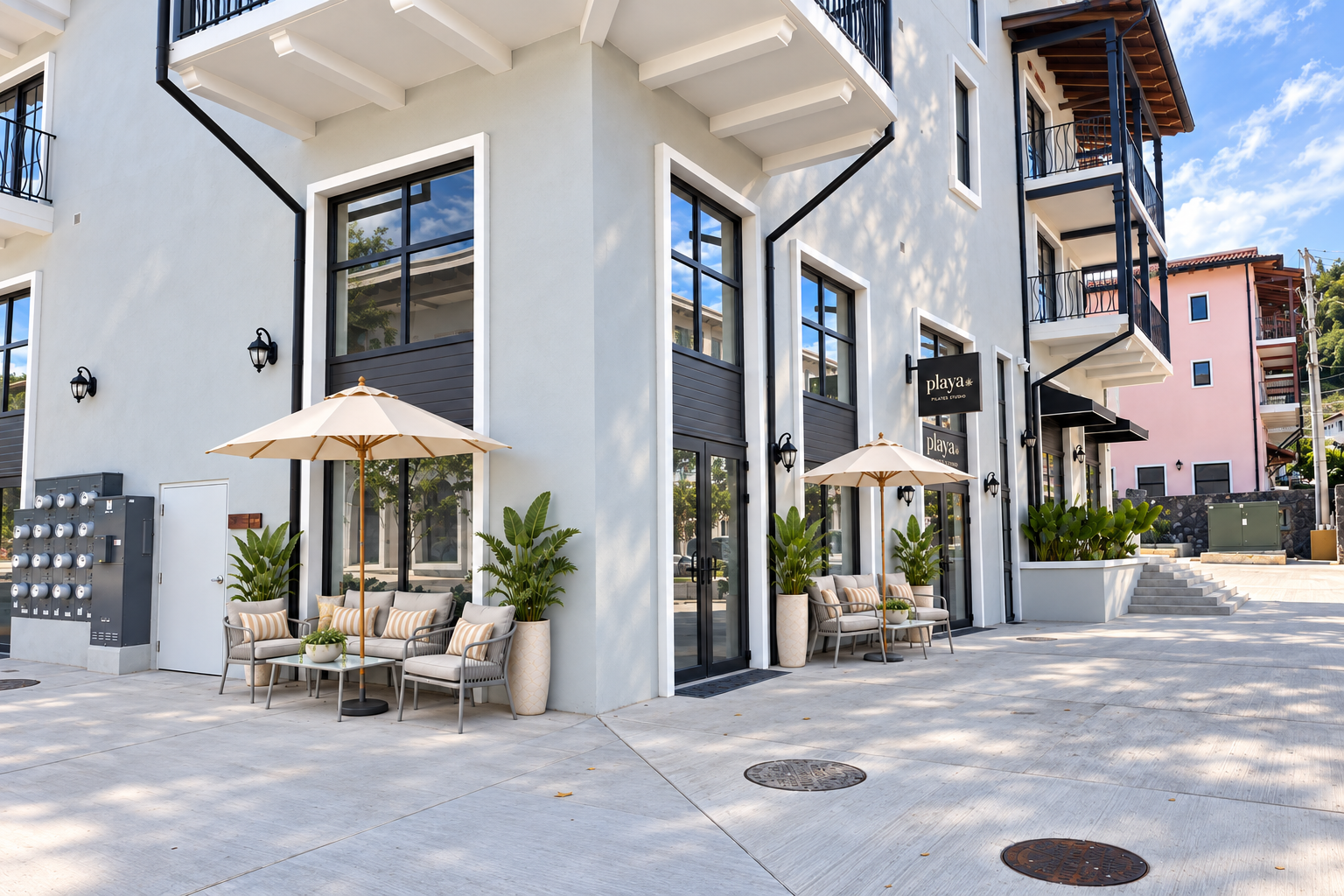 Playa exterior design at Building 47, showing the projecting black sign and entrance beside the planter and stairs